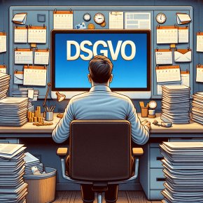 Mann sitzt an einem vollen Schreibtisch und bearbeitet DSGVO-Anfragen